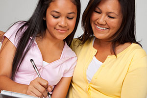 Girl and mom filling out paperwork at doctor's office