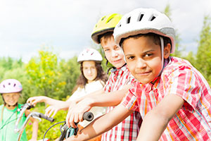 Kids on bikes wearing helmets