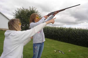 Parent showing teen how to shoot a gun