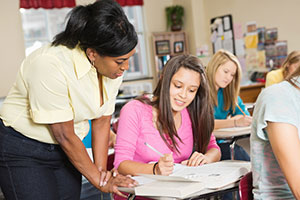 Teen girl in class with teacher