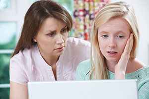 Mom and daughter looking at computer