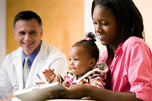 Mom filling out paperwork with baby