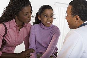 Mom and daughter talking to doctor