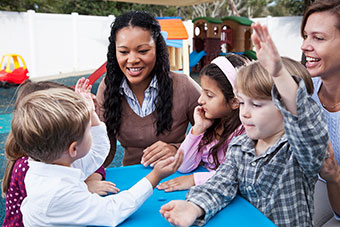 Teacher with students on playground