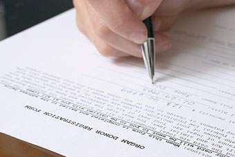 Parent filling out organ donor registry form