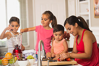 Mom preparing food with her children