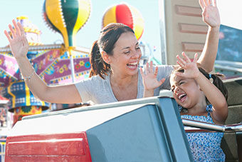 Mom and daughter on theme park ride