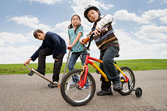 kids on bikes, skateboards, and scooters