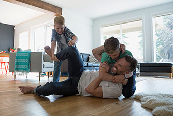 Dad and sons wrestling