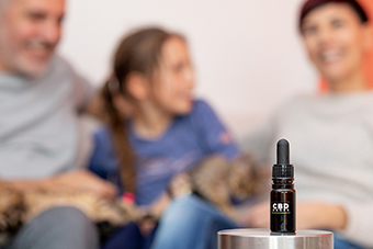 Parents and child with CBD oil bottle