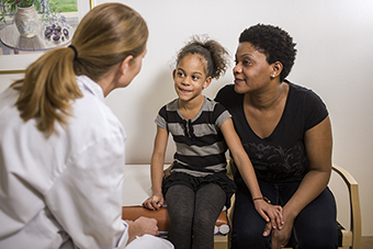 Mom and daughter talking to doctor