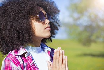 Teen girl praying outside