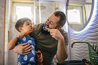 Dad and son brushing teeth