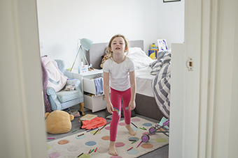 young girl throwing a tantrum in her bedroom