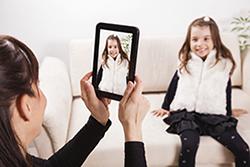 Mom taking photo of daughter