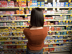 Woman trying to choose an allergy medicine