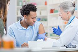 Teen boy getting vaccine
