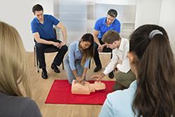 Teens learning CPR