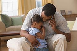 dad comforting crying toddler