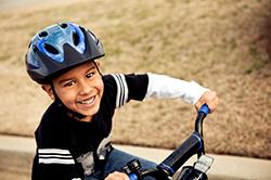Boy riding a bike with a helmet